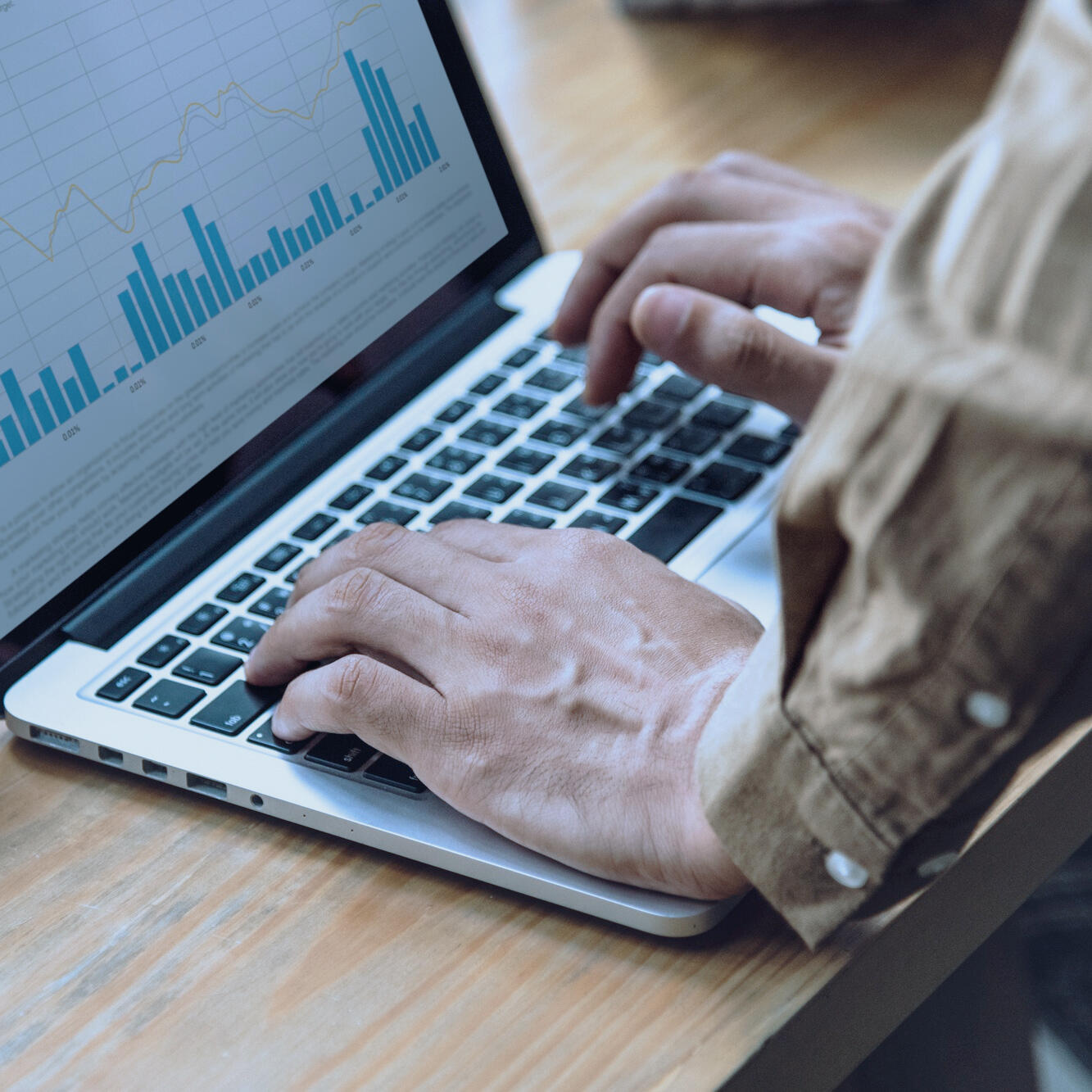 Hero picture Laptop with hands and analytics.